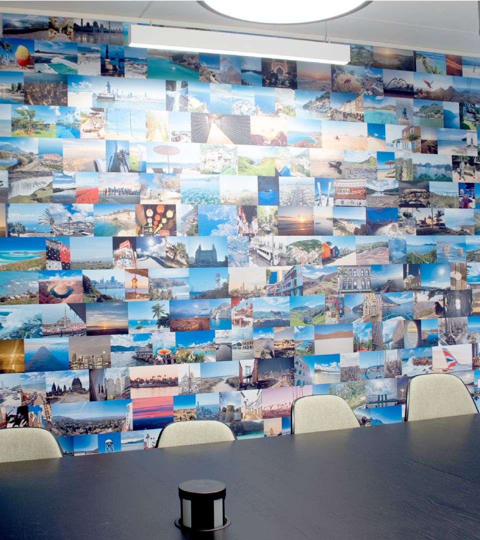 Photo collage of holidays on the wall of an office space