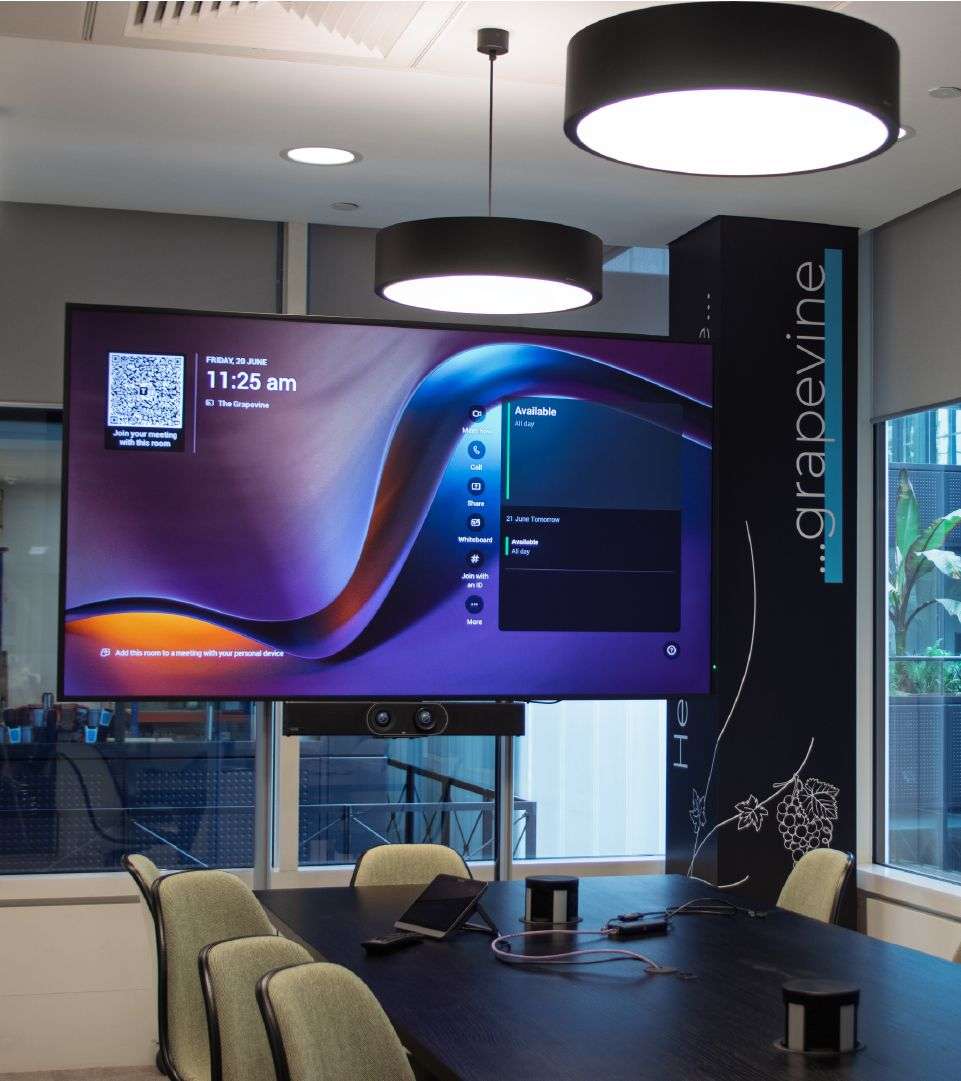Large screen TV on the wall of an office space