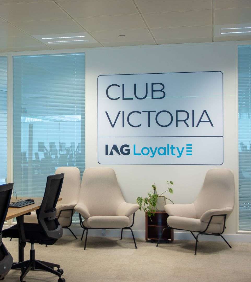 'Club Victoria' and IAG Loyalty logo on the wall of an office space