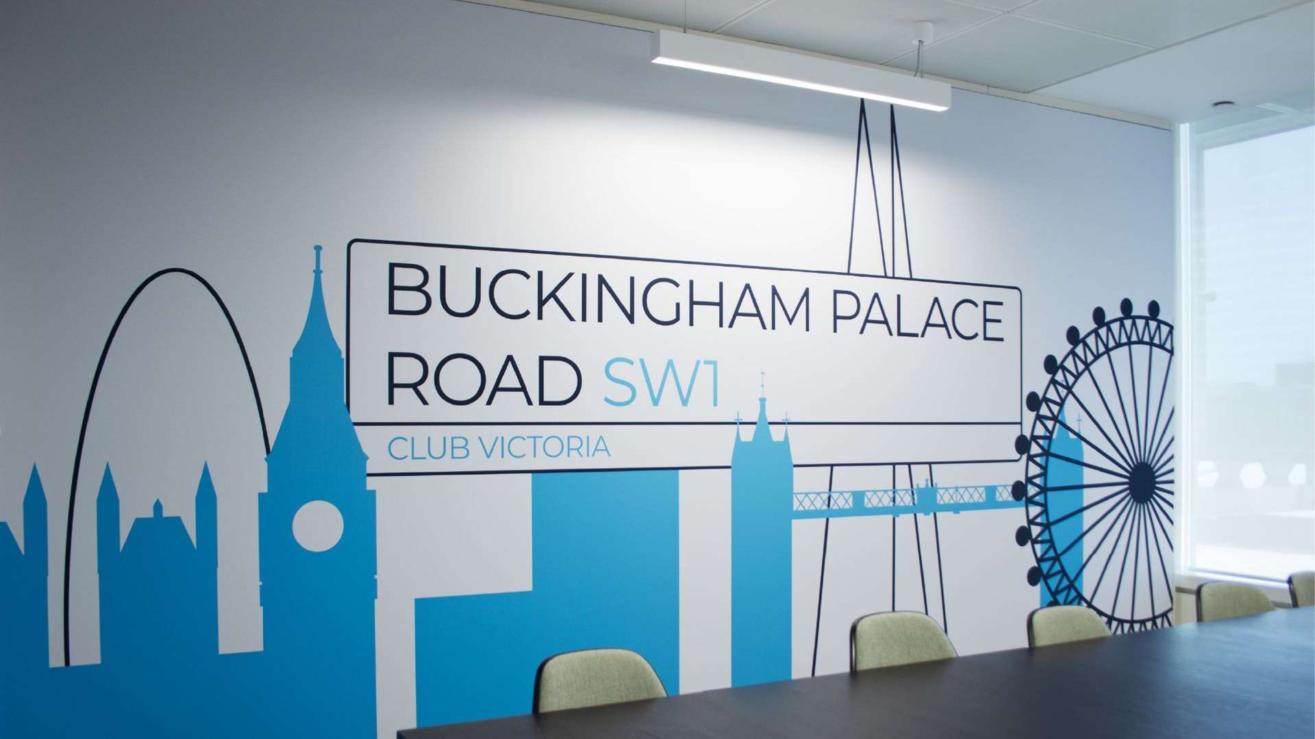 'Buckingham Palace Road SW1' and London skyline graphics on the wall of an office space