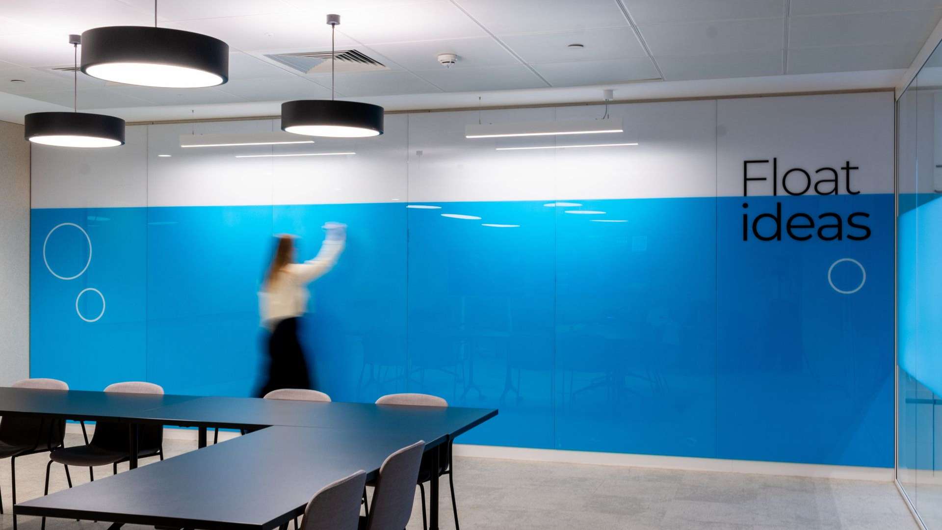 A blue and white glass wall with the words 'Floating ideas'
